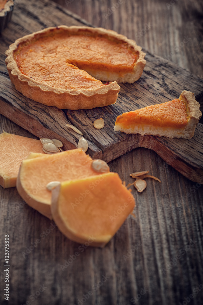 Thanksgiving pumpkin pie on wooden background with copy space