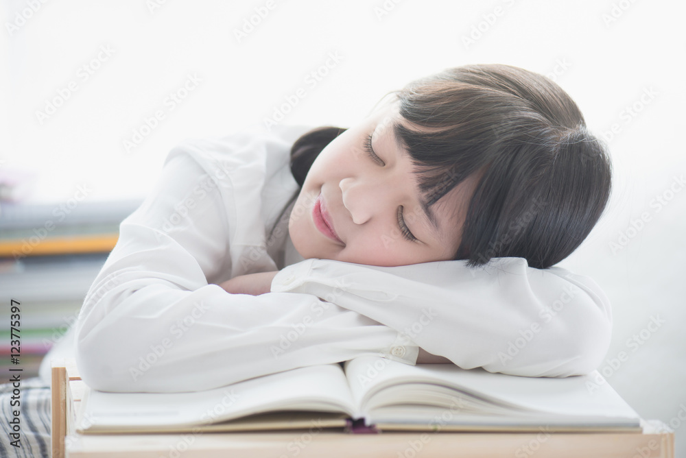 Beautiful Asian girl sleeping on the books Beautiful Asian girl sleeping on the books