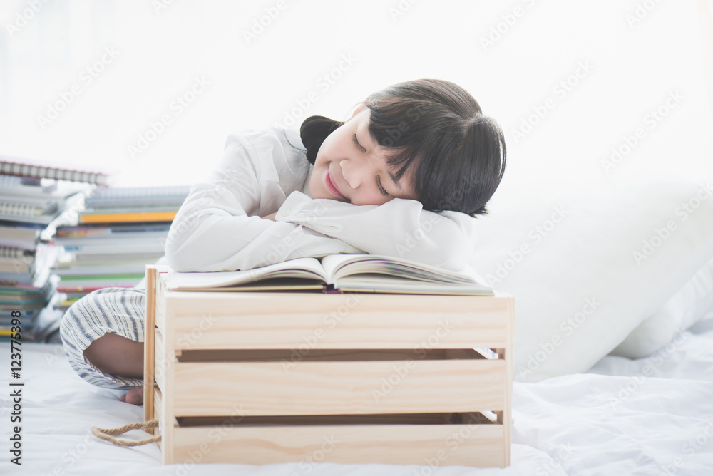 Beautiful Asian girl sleeping on the books Beautiful Asian girl sleeping on the books