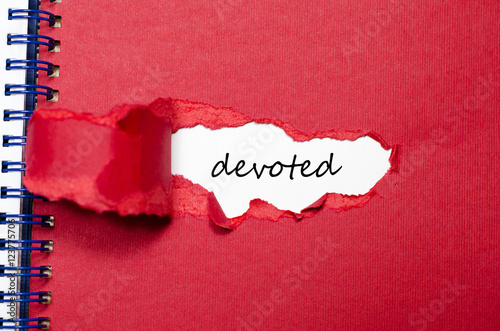 The word devoted appearing behind torn paper photo