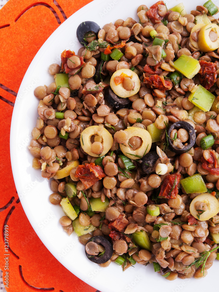 Lentil salad with green peppers, dried tomatoes and olives