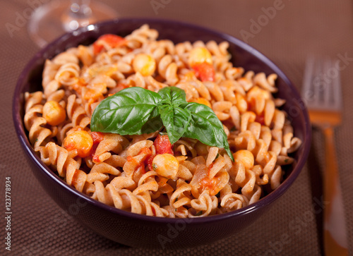 Italian fusilli pasta with chick-peas, close up, decorated with