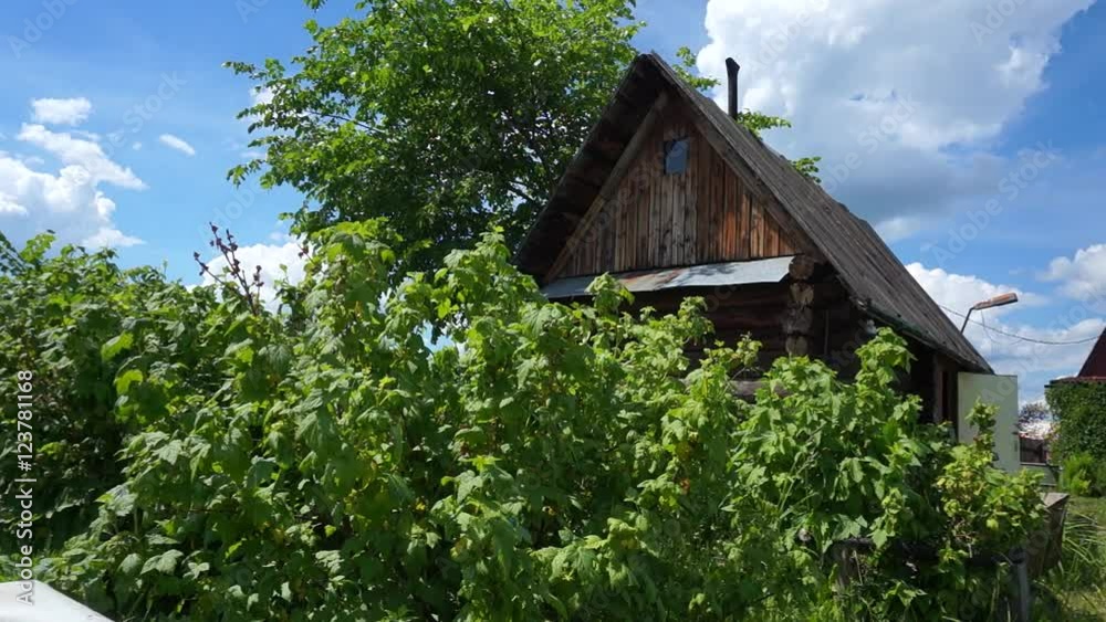 Country sauna, sauna, among the bushes on blue sky background. The summer season in the village. Dolly shot. Country sauna, sauna, among the bushes on blue sky background. The summer season in the village. Dolly shot.