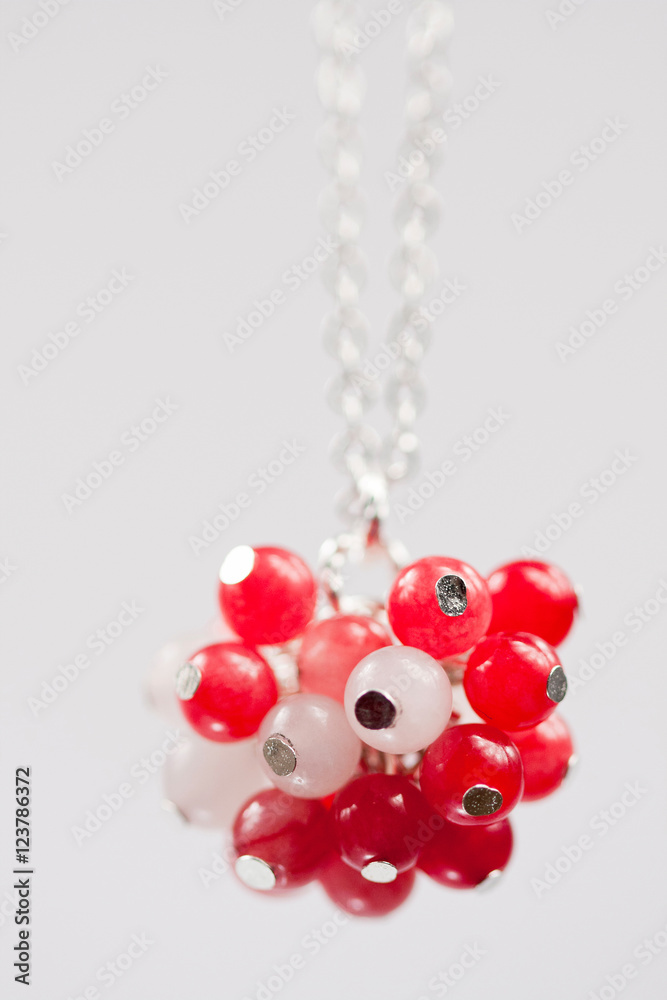 Silver jewels with colorful precious stones and light grey background