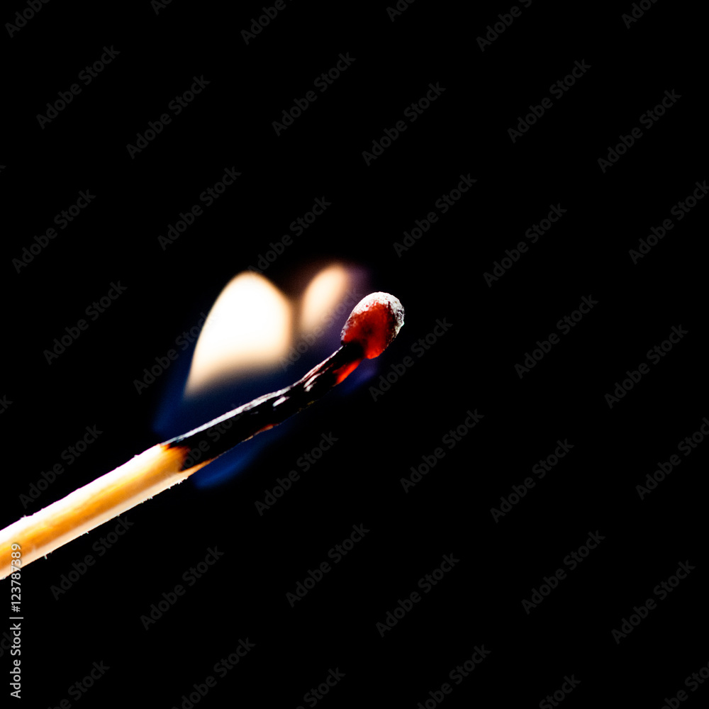 Used match and flame with black background Used match and flame with black background