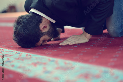 Younger Muslim man praying