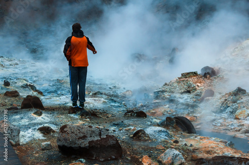 Tourist watching hot stream in Iceland