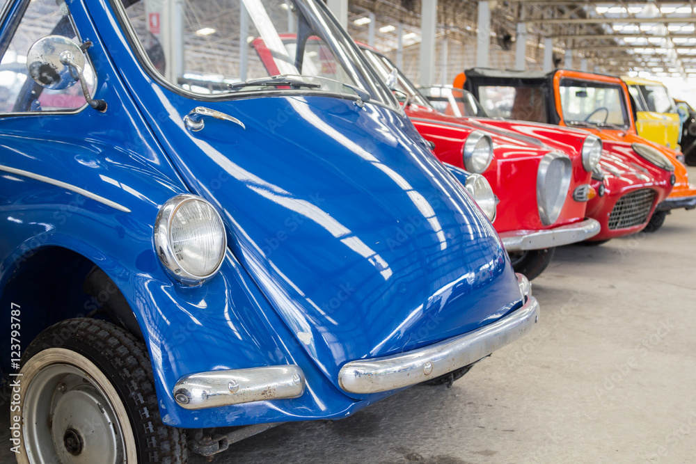 blue retro and classic car in big garage