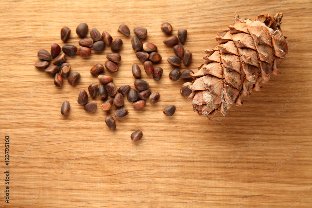 Walnut and pine nuts on a cutting board made of oak/ Walnut and pine nuts on a cutting board made of oak Walnut and pine nuts on a cutting board made of oak/ Walnut and pine nuts on a cutting board made of oak