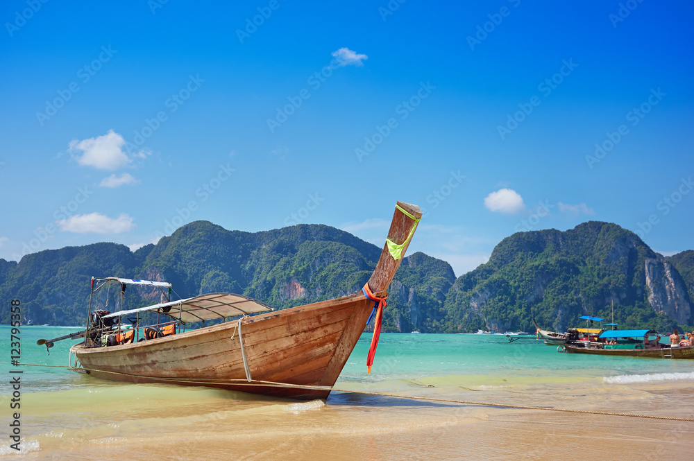 Longtail boat in the beautiful sea over clear sky Longtail boat in the beautiful sea over clear sky