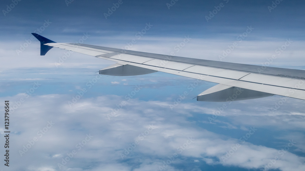 The airplane wing on the beautiful cloudy and sky. The airplane wing on the beautiful cloudy and sky.