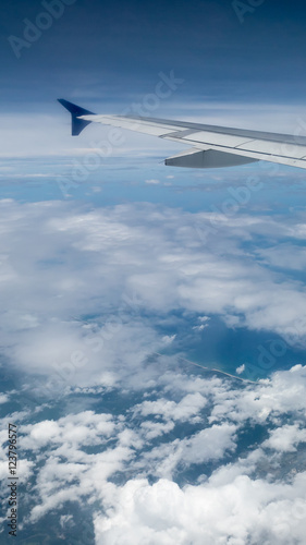The airplane wing on the beautiful cloudy and sky.