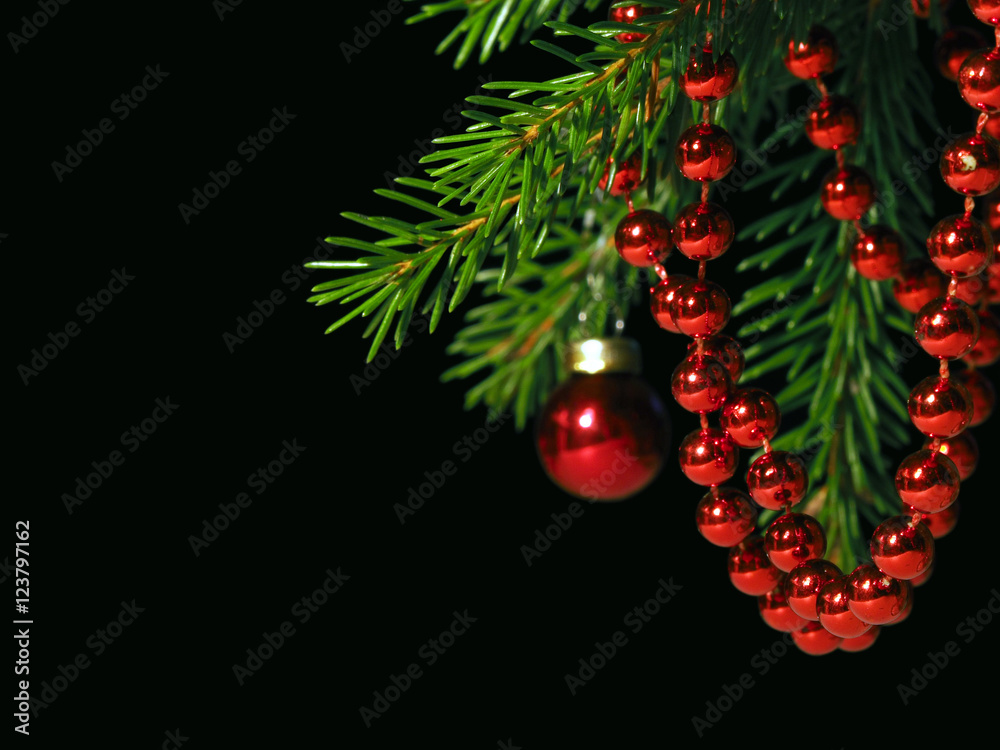 New year composition on a black background. Decorated Christmas tree. Red beads, balls