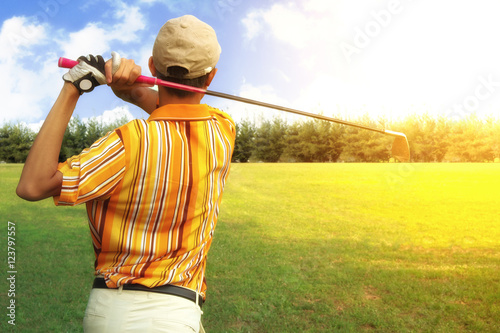 Golfers men player golf hit swing shot on course in sunrise