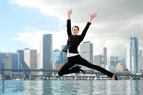 Photography Happy Businesswoman Leaping with Miami Skyline in Background