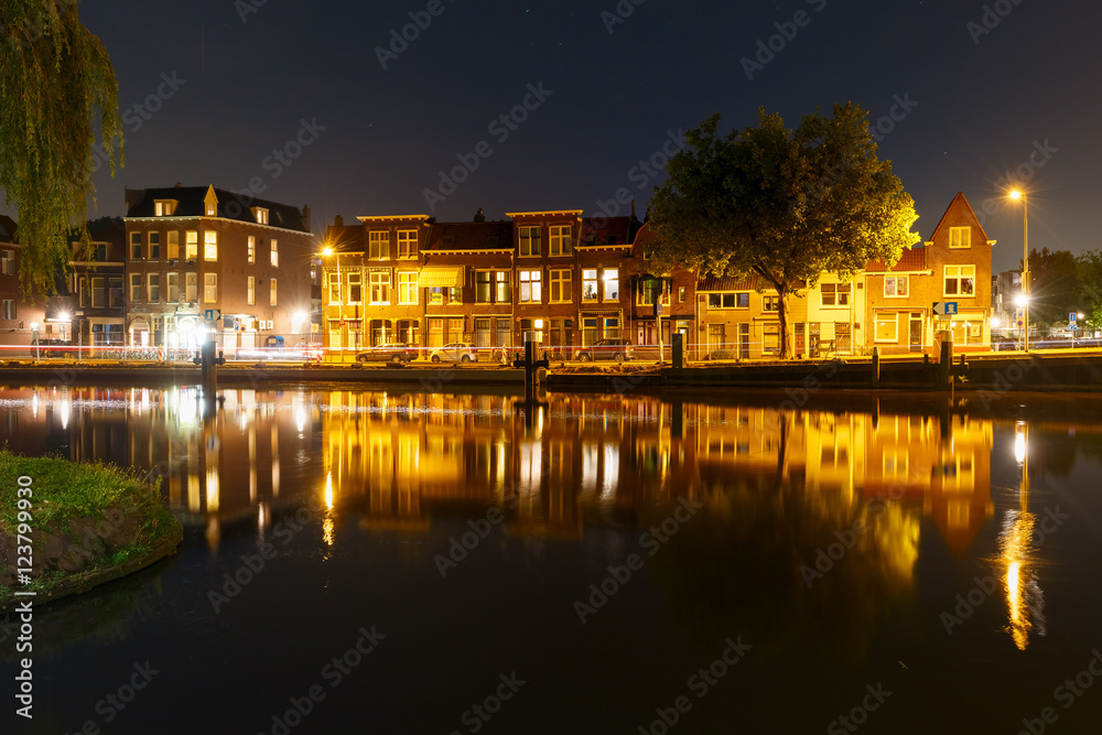 Night canal and typical dutch houses with their reflections in Delft, Holland, Netherlands