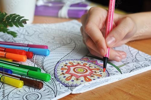 Coloring an adult coloring book