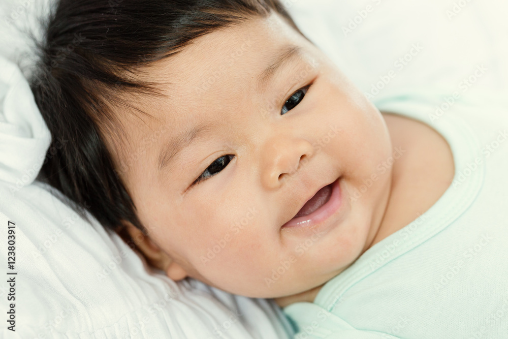 Adorable baby girl smile on the bed. Adorable baby girl smile on the bed.
