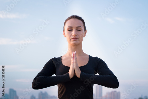 Pretty fitness woman training on pier during morning sport worko photo