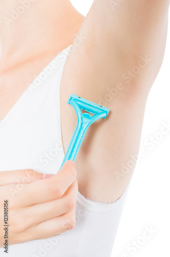 Woman shaves armpit blue shaver .On White, isolated background.