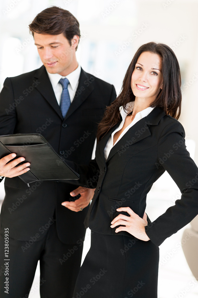Businesswoman and Businessman in Lobby