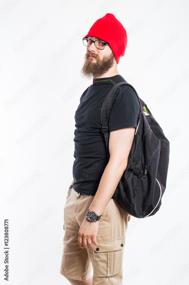 a man with a beard in a red cap and glasses. With a backpack. On white, isolated background. a man with a beard in a red cap and glasses. With a backpack. On white, isolated background.