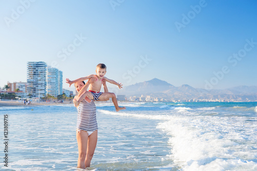 Family has fun at the seashore in summertime