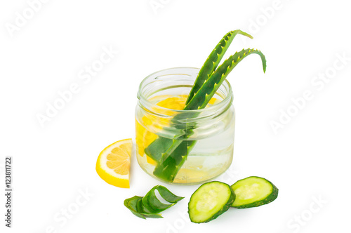 Herbal set. Aloe Vera in a glass jar, slices of lemon and cucumber. On white, isolated background.