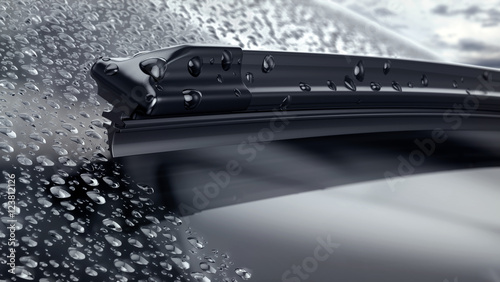 Car windshield with rain drops and frameless wiper blade closeup. 3d render