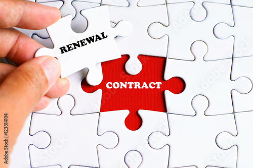 "CONTRACT" word on missing puzzle with a hand hold a piece of "RENEWAL" word puzzle want to complete it - business and finance concept