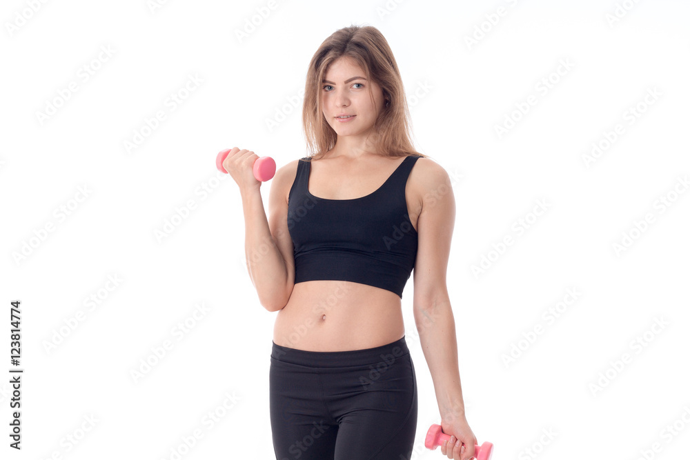 sports girl looking forward bending one arm holding a dumbbell sports girl looking forward bending one arm holding a dumbbell