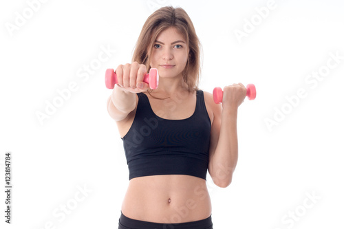 Fitness woman a stretched out a hand with a small dumbbell © ponomarencko