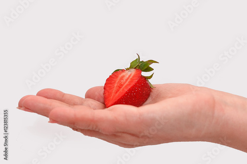 Woman holding in hands ripe fresh strawberries isolated on white background.