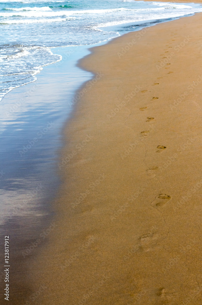 Human footprints on the wet Golden sand