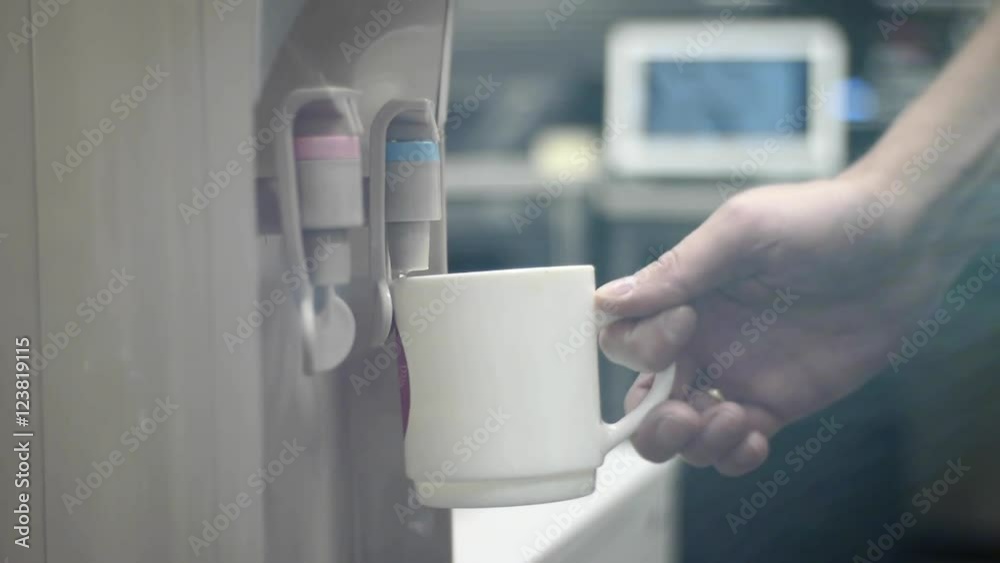 a man pours water from a cooler a man pours water from a cooler