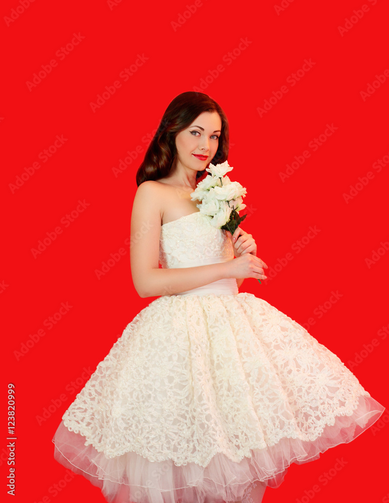 Beautiful bride woman in white wedding dress with bouquet of flo