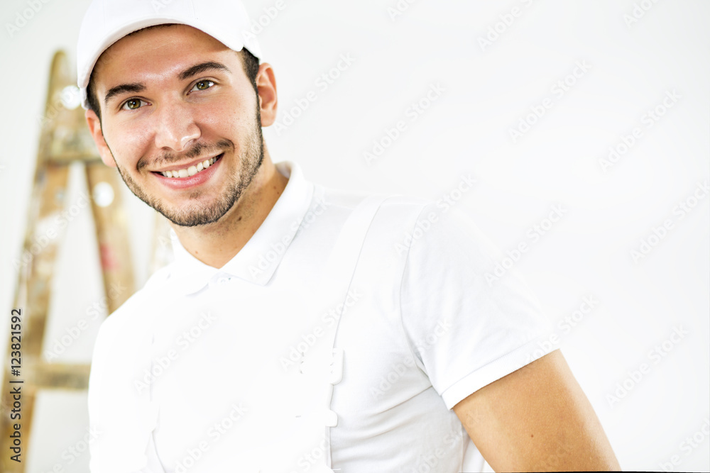 Portrait of young worker..
Young worker posing and smiling. Ladder in a background. Portrait of young worker..
Young worker posing and smiling. Ladder in a background.