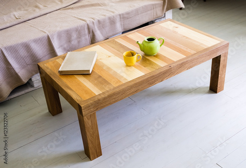 Coffee table with top made of different kinds of wood