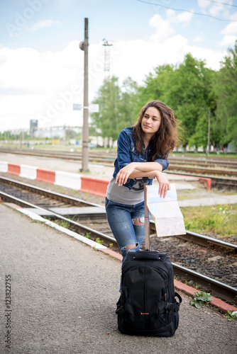 tourist girl waiting at the railway track