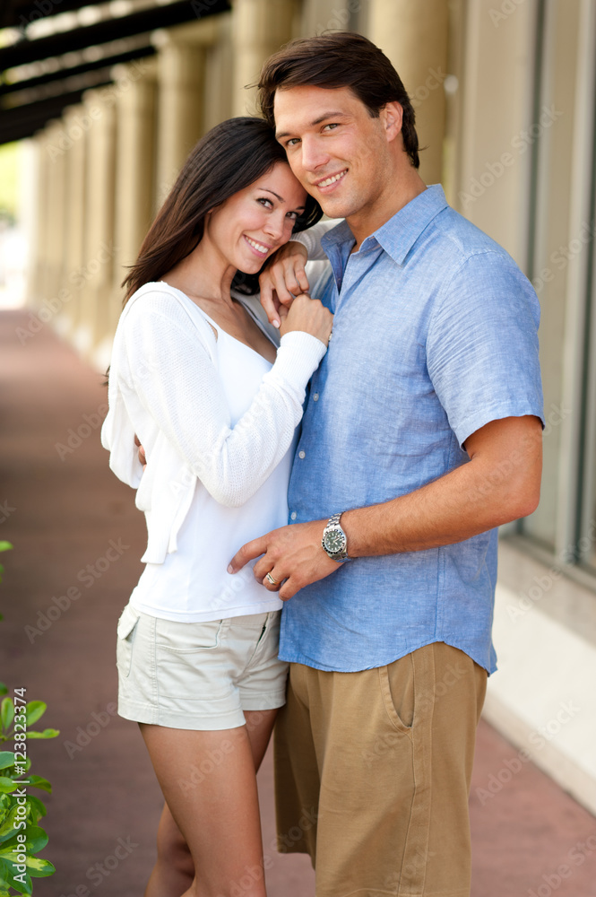 Naklejka premium Young Couple Cuddling near Stores