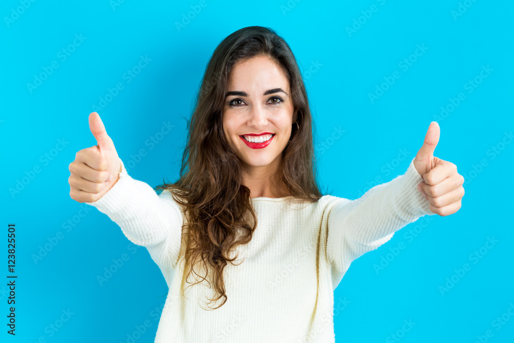 Happy young woman giving thumbs up Happy young woman giving thumbs up