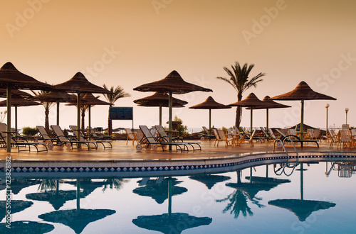 Obraz na płótnie Swimming pool with palm trees at morning. Egypt