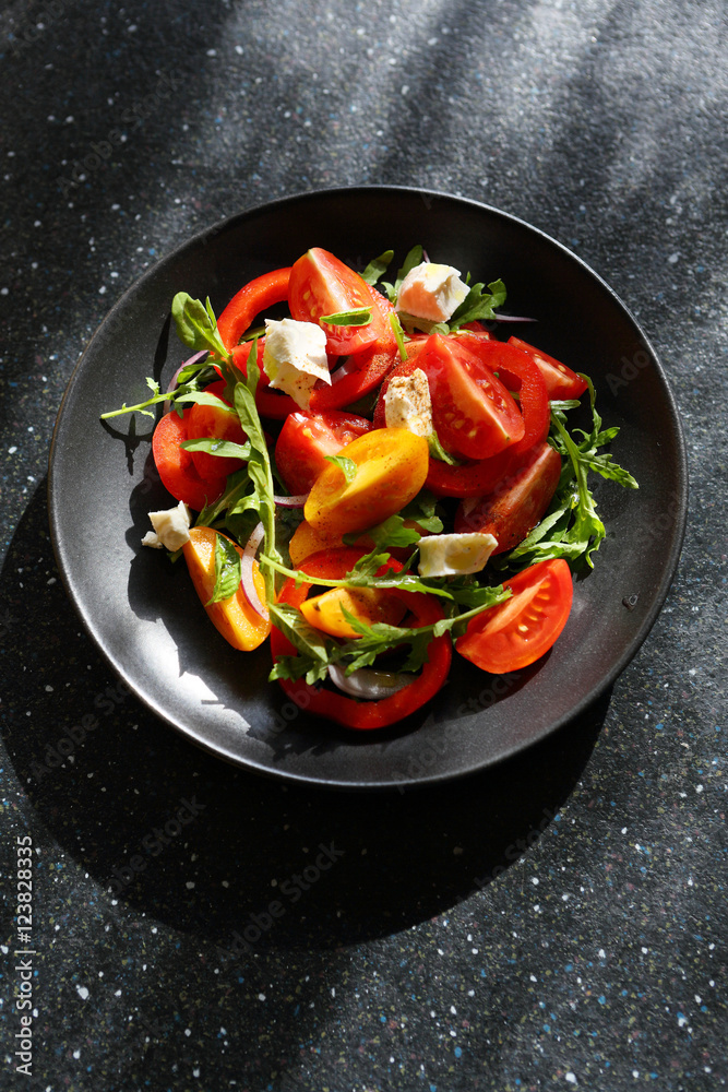Healthy salad on black plate