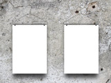Two blank frames hanged by clothes hangers against monochrome concrete wall background