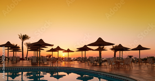 Swimming pool with palm trees at morning. Egypt