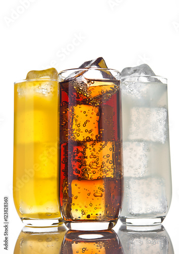 Glasses with cola orange soda and lemonade ice photo