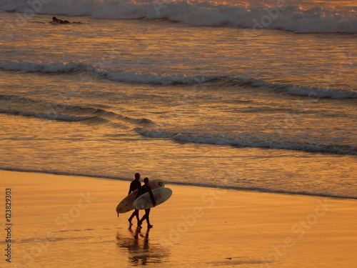 Surfer im Sonnenuntergang an der Fistral Bay in Newquay, Cornwall,  photo