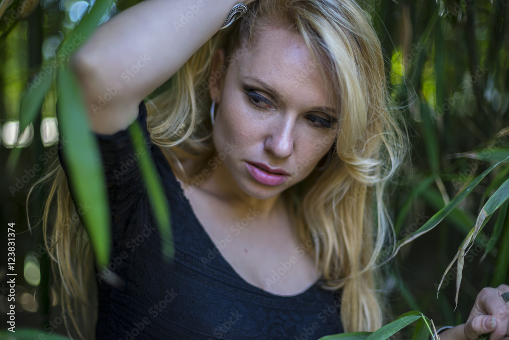 spring, beautiful blonde with long black discharge between branc spring, beautiful blonde with long black discharge between branc