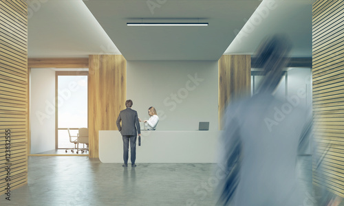 Two men and a woman in company corridor