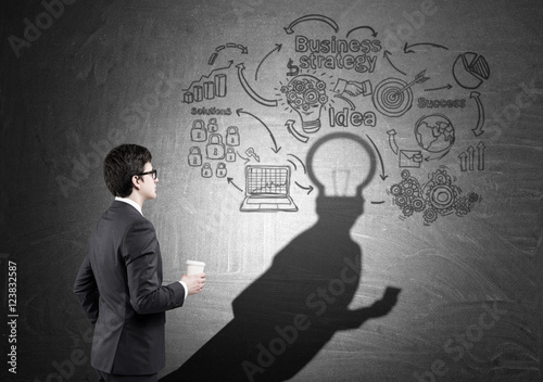 Man with light bulb head near startup sketch